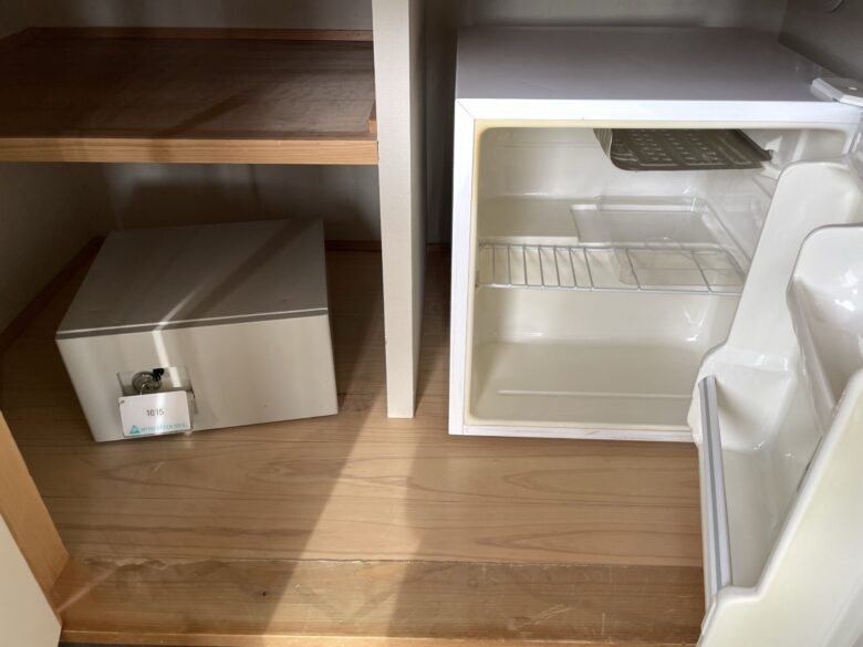 Safe and mini-fridge behind sliding doors