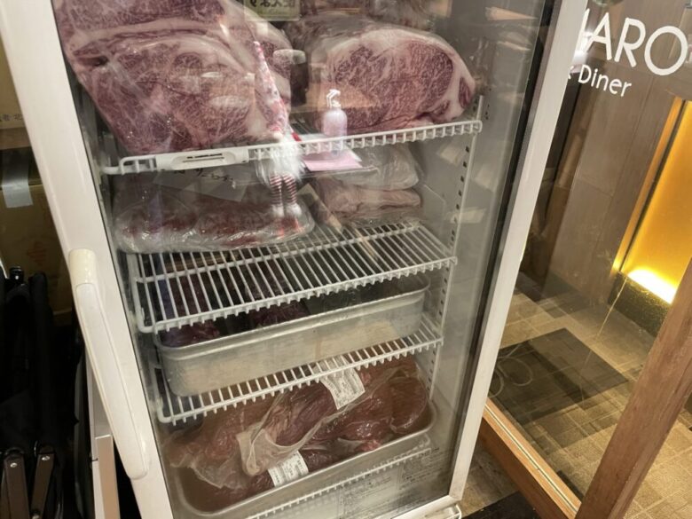 Freezer display of meat blocks near the entrance